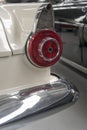 Chrome plated fin with round rear light and shining bumper of vintage 50`s car, Wanaka, New Zealand