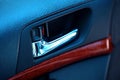 Chrome-plated inside car door handle that opens it from the inside. Royalty Free Stock Photo