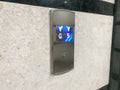 Chrome plated or stainless steel finished Floor indicator panel fixed on a granite finished wall cladding and fixed in between the