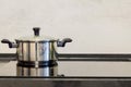 Chrome pot on electric stove, modern black and white kitchen Royalty Free Stock Photo