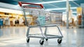 Chrome shopping cart in empty supermarket aisle Royalty Free Stock Photo