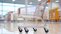 Chrome shopping cart in empty supermarket aisle Royalty Free Stock Photo