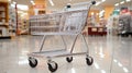 Chrome shopping cart in empty supermarket aisle Royalty Free Stock Photo