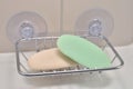 Chrome soap tray, wall mounted holder dish, white porcelain china basin, beige tiles, used green, creamy ivory soap bars, large