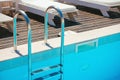 Chrome stairs with empty swimming pool Royalty Free Stock Photo