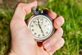 Chrome stopwatch in hand. Measuring time with a stopwatch.