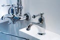 Chrome washbasin faucets in a plumbing shop. Trade in modern bathroom accessories Royalty Free Stock Photo