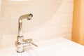 Chrome water faucet with marble counter tops and a white sink.Luxury faucet mixer .Tap water in the kitchen. The Royalty Free Stock Photo