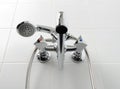 Chrome water tap in white bathroom Royalty Free Stock Photo