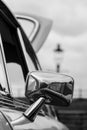 Chrome wing mirror of a restored Austin Marina open during a Classic Car Rally - Black & White