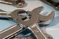 Chrome wrenches lying on checkered surface ready for work Royalty Free Stock Photo