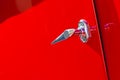 Chromed handle detail on red background of a vintage sports car Royalty Free Stock Photo
