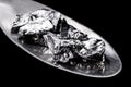 Chromium fragments on trowel, industrial use ore, metallic chemical element, isolated on black background