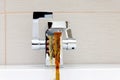 Chromium-plate tap with rusty, dirty water. Royalty Free Stock Photo