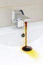 Chromium-plate tap with rusty, dirty water. Royalty Free Stock Photo