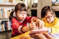 Cute lovely sisters with chromosome abnormality drawing with crayons