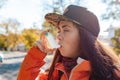 Chronic disease. Close up portrait of a teenage girl using an inhaler on the street  having an asthma attack. Outdoor Royalty Free Stock Photo