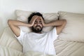 Chronic Migraine. Sick Young Indian Man Suffering Headache While Lying In Bed Royalty Free Stock Photo