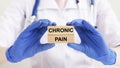 Chronic pain text on wooden blocks in doctor hands