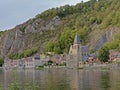 Church and houses along river Meuse under the cliffs of Dinant