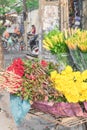 Chrysanthemum, rose and water lily arranged on bicycle street vendor in Hanoi