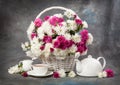 Chrysanthemums in a basket on a wooden table. Still life