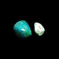 Two tumbling chrysocolla stones on black background Royalty Free Stock Photo