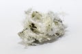 Chrysotile asbestos fibers lie in a heap on white background Royalty Free Stock Photo