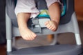 chubby baby legs feet. Small kid sitting in high chair