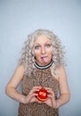 Chubby blonde girl wearing summer dress and posing with big red apple on white background alone Royalty Free Stock Photo