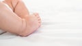 A chubby foot of little baby on white sheet background. Newborn age of 3 months Royalty Free Stock Photo