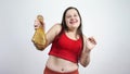 Chubby girl dances with a chicken leg in his hand.Bodypositive,body positive.