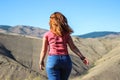 Chubby girl tourist with red hair in jeans