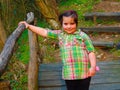 A chubby little girl on a wooden bridge