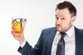 Man in formal wear looking at camera while holding glass of beer with glasses on isolated on white Royalty Free Stock Photo