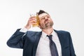 Man in formal wear posing with glass of beer on white Royalty Free Stock Photo