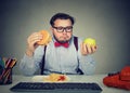 Stressed man at workplace having diet problems Royalty Free Stock Photo