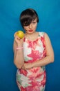 Chubby plus size woman holding green apple on blus studio solid background