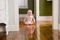 Chubby seven month old baby at home on floor