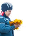 Chubby teenage boy holds bunch of autumn leaves Royalty Free Stock Photo