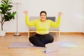 Chubby woman exercises at home for health and fitness Royalty Free Stock Photo