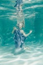 Chubby woman in grey evening long dress swimming underwater on her holidays and enjoy with relax Royalty Free Stock Photo