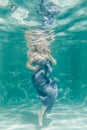 Chubby woman in grey evening long dress swimming underwater on her holidays and enjoy with relax Royalty Free Stock Photo