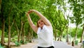 Chubby woman streching in the park Royalty Free Stock Photo