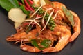 Chuchi shrimp on a plate with fresh pepper seeds