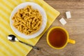 Chuck-chuck in plate, teaspoon on napkin, tea, sugar cubes Royalty Free Stock Photo