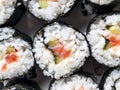 Chumaki Sushi Rolls with Tuna, Salmon, Rice, Cucumber, Avocado And Nori Seaweed on a Plate with Soy Sauce Dipping Dish and Royalty Free Stock Photo