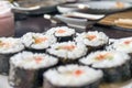 Chumaki Sushi Rolls with Tuna, Salmon, Rice, Cucumber, Avocado And Nori Seaweed on a Plate with Soy Sauce Dipping Dish and Royalty Free Stock Photo