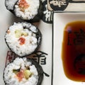 Chumaki Sushi Rolls with Tuna, Salmon, Rice, Cucumber, Avocado And Nori Seaweed on a Plate with Soy Sauce Dipping Dish and Royalty Free Stock Photo