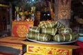 Chung cake on altar in old village communal house. Cooked square glutinous rice cake, Vietnamese lunar new year food